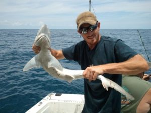 Ian Martin, Certified KY Arborist, holding a fish he caught while deep sea fishing